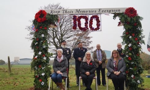 Participants beneath the EverGreen Arch, decorated for the memorial centenary.