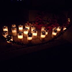 A ring of remembrance candles illuminated at night.