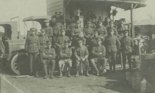 Army Service Corps soldiers beside a motor vehicle.