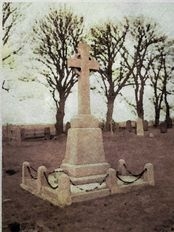A memorial cross in a churchyard.