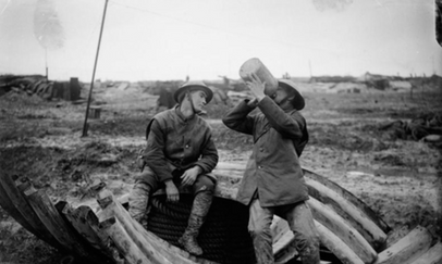 Soldiers sharing a rum ration in the trenches.
