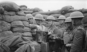 Soldiers sharing a drink in the trenches.