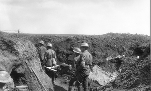 Soldiers moving through a trench.