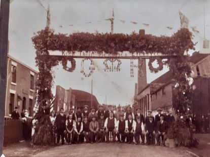Villagers beneath the Marston EverGreen Remembrance Arch, circa 1918.